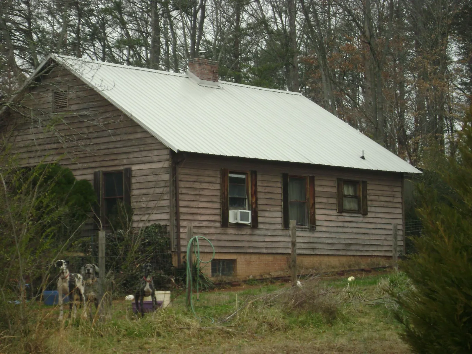 White metal roof on an old wood sided farmhouse, from a Metal Roof Installation job in Red Bank
